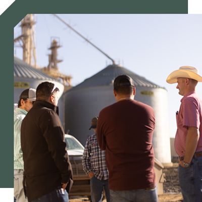 Male Friona employees standing in a group outside